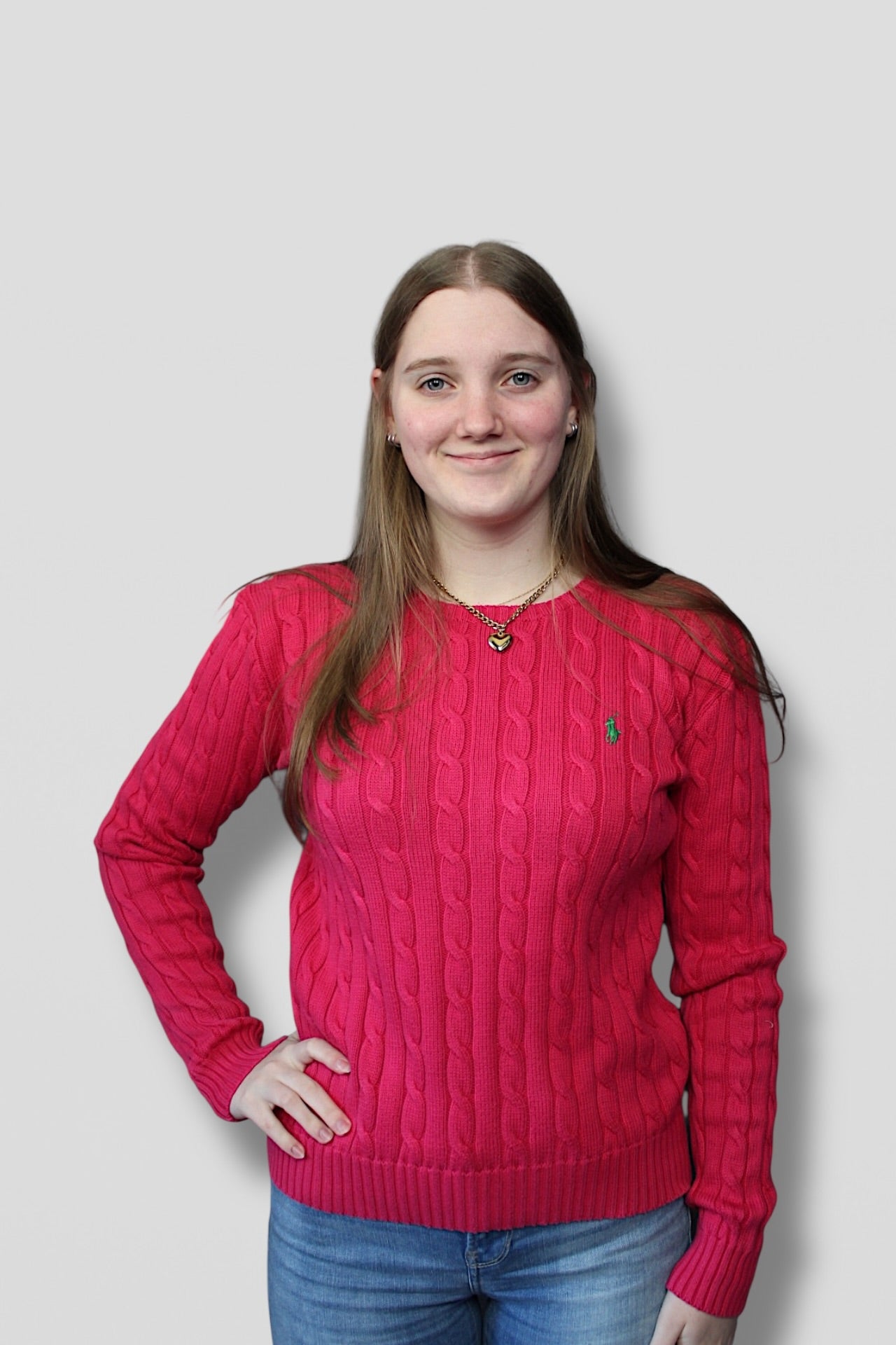 Woman wearing a red sweater against a plain background