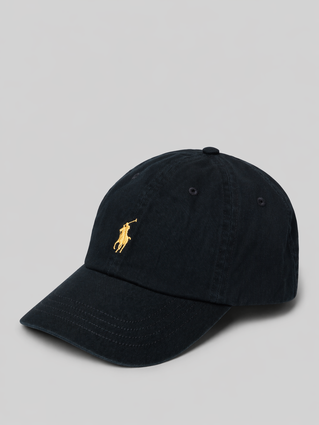 Black cap with a gold embroidered logo on a light gray background